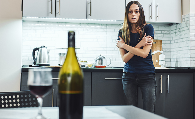 woman-in-fear-of-bottle-of-alcohol-on-table Woma