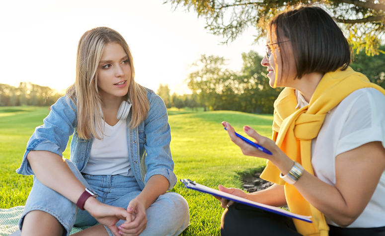 Woman sat outside participating in a CBT therapy session