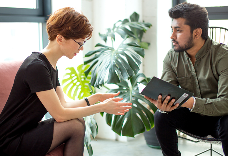 Woman discussing weight loss and addiction with her therapist