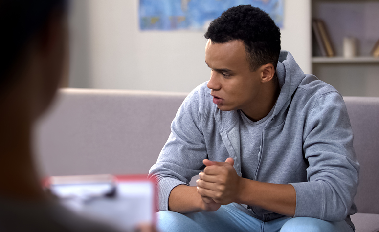 Man with addiction to cannabis discussion his problems with a mental health expert