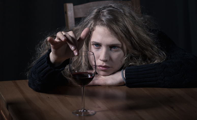 Woman with alcohol dependency totally obsessed with her drink